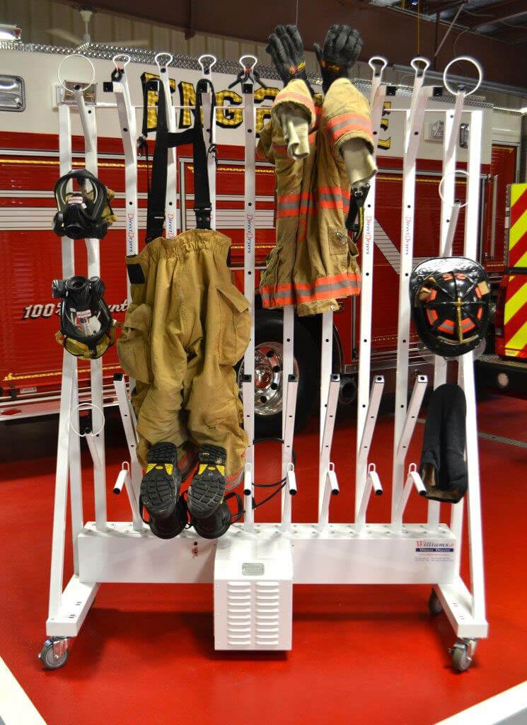 Dryer with fire gear loaded onto it in firehouse