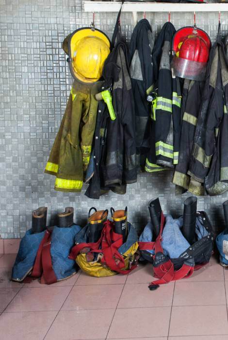 Fire fighter gear hanging on racks