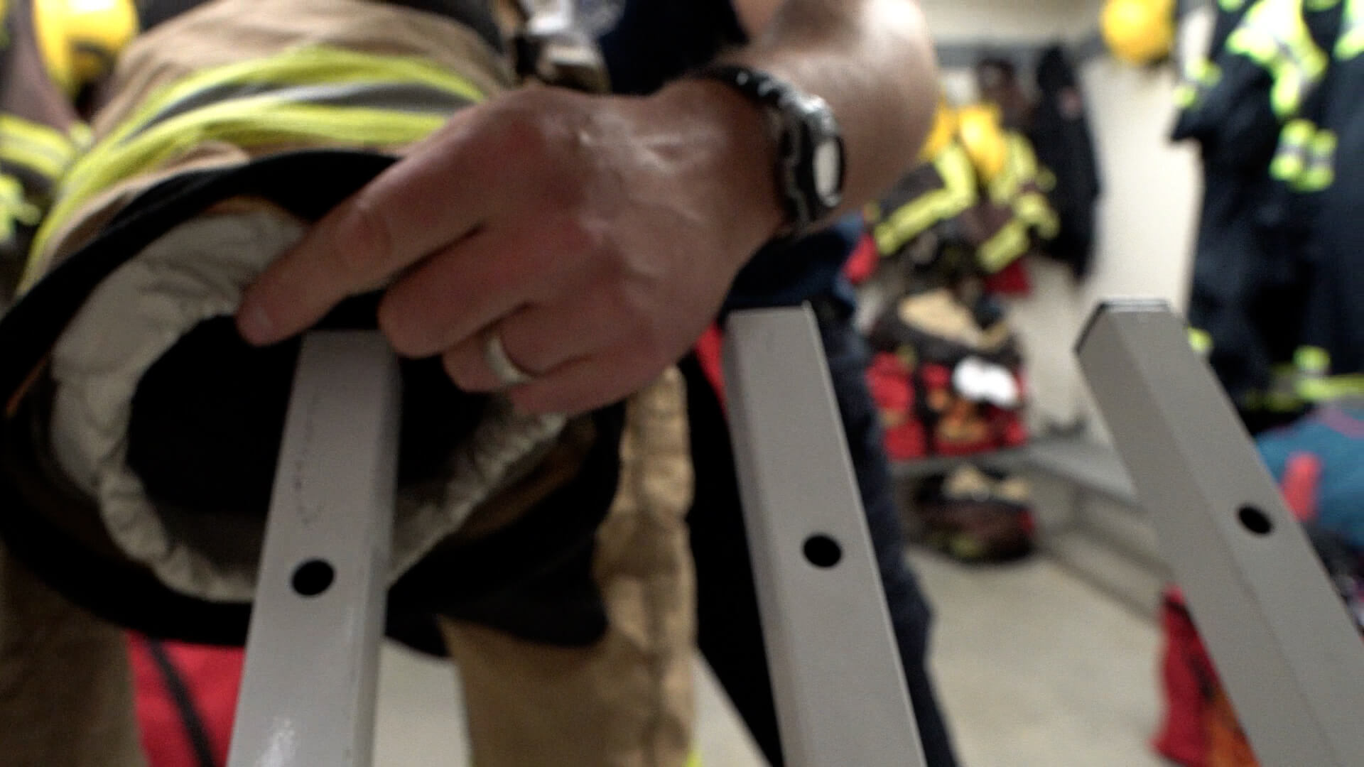 Fire fighter pulling coat off of dryer